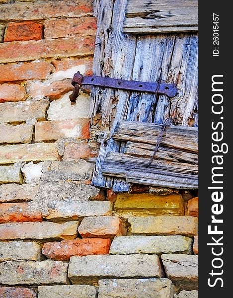 Old wooden grunge window detail over bricks background