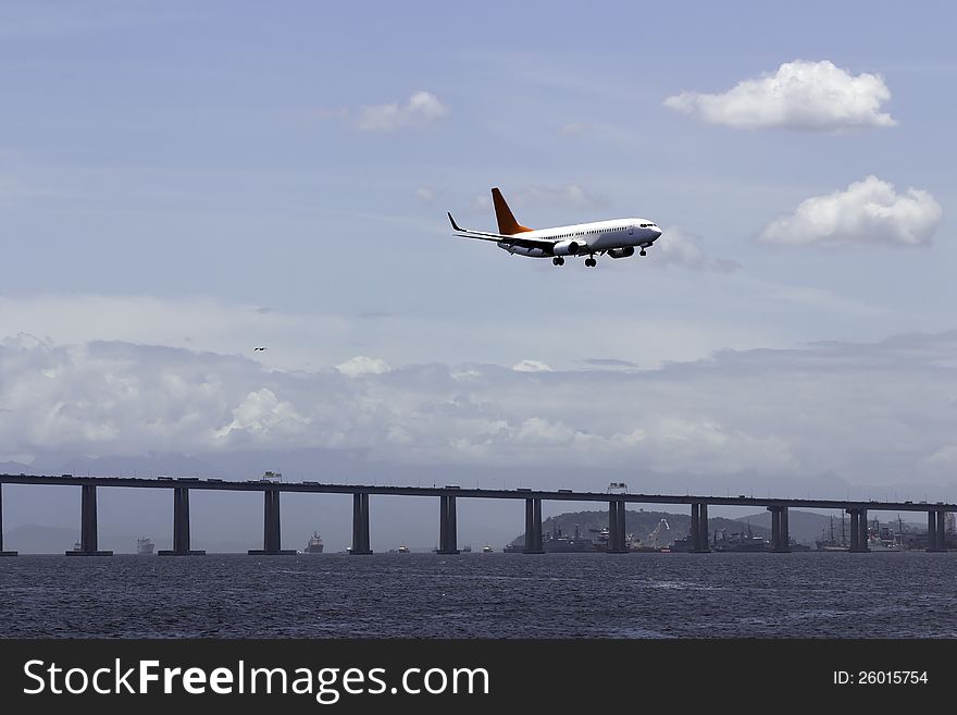 Airplane landing in Rio De Janeiro on the bridge background