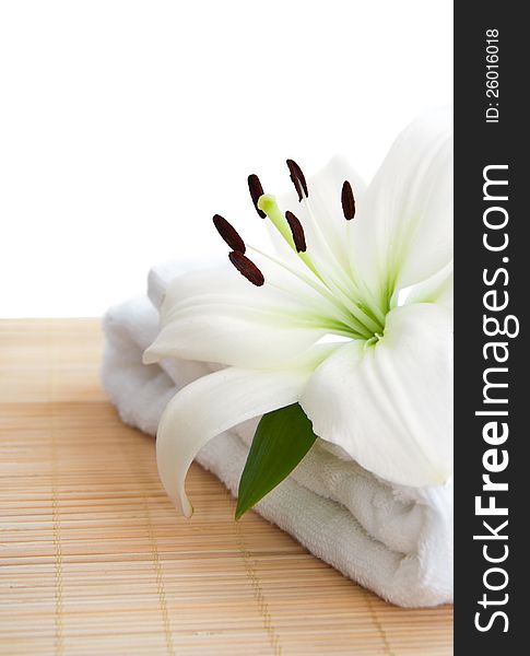White lily and  towel  on a white background. White lily and  towel  on a white background