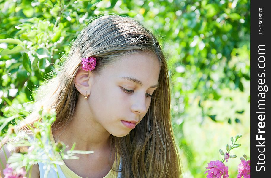 Portrait of beautiful l girl in the flower garden. Portrait of beautiful l girl in the flower garden