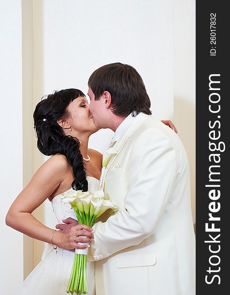 Kiss bride and groom at wedding ceremony