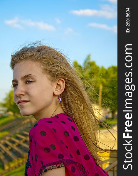 Preteen female outdoors on a sunny, breezy day