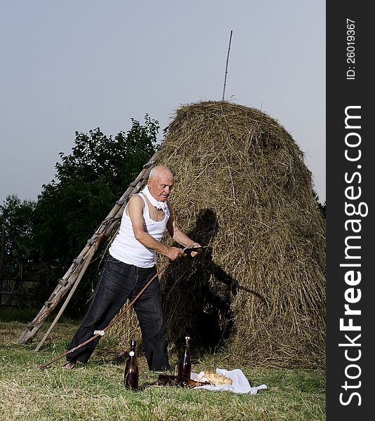 Senior farmer using scythe to mow the lawn traditionally. Are important: the sickle, hammer and anvil. This operation was carried out at the end of the day. the food was bread, cheese and wine. A scythe is an agricultural hand tool for mowing grass, or reaping crops. It was largely replaced by horse-drawn and then tractor machinery, but is still used in some areas of Europe and Asia. Senior farmer using scythe to mow the lawn traditionally. Are important: the sickle, hammer and anvil. This operation was carried out at the end of the day. the food was bread, cheese and wine. A scythe is an agricultural hand tool for mowing grass, or reaping crops. It was largely replaced by horse-drawn and then tractor machinery, but is still used in some areas of Europe and Asia.