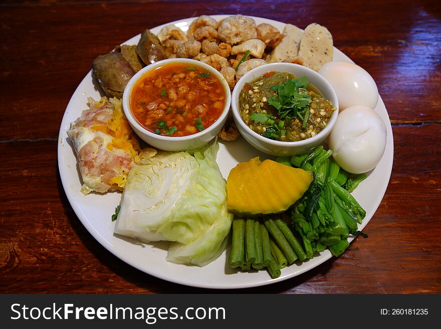 A top view shot of nam prik & x28 chili& x29  served with sai oua & x28 Thai sausage& x29 , kab moo & x28 crispy pork rind& x29