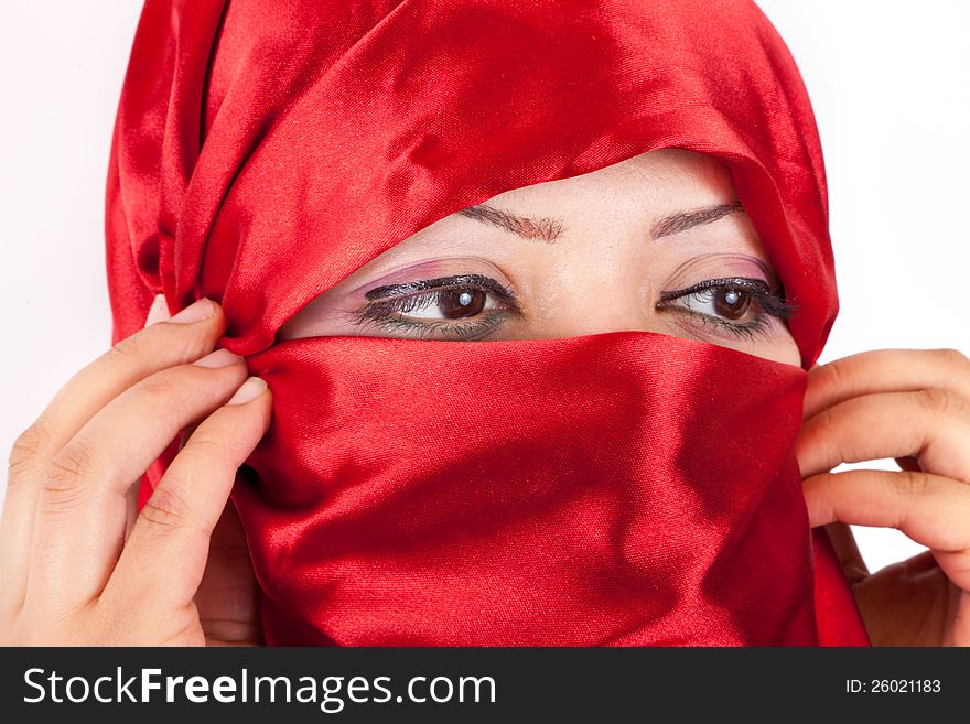 Portrait of a middle eastern woman wearing red traditional clothing ( Niqab ). Portrait of a middle eastern woman wearing red traditional clothing ( Niqab )
