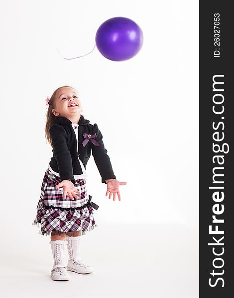 Birthday girl playing with her balloon.