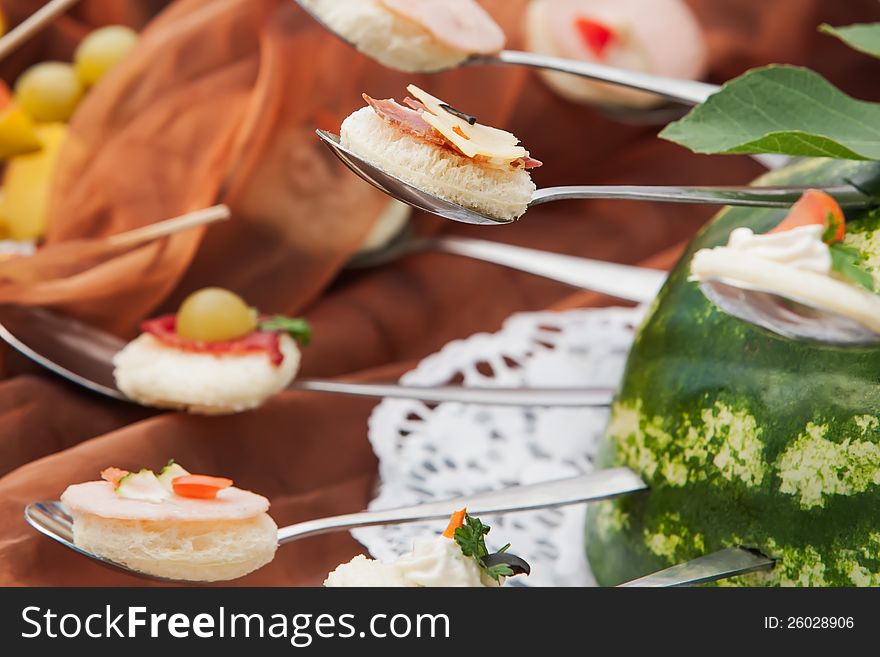 A spoon of circled breads with filling. A spoon of circled breads with filling.