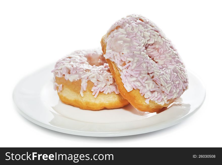 Iced And Sprinkled Doughnuts On Plate