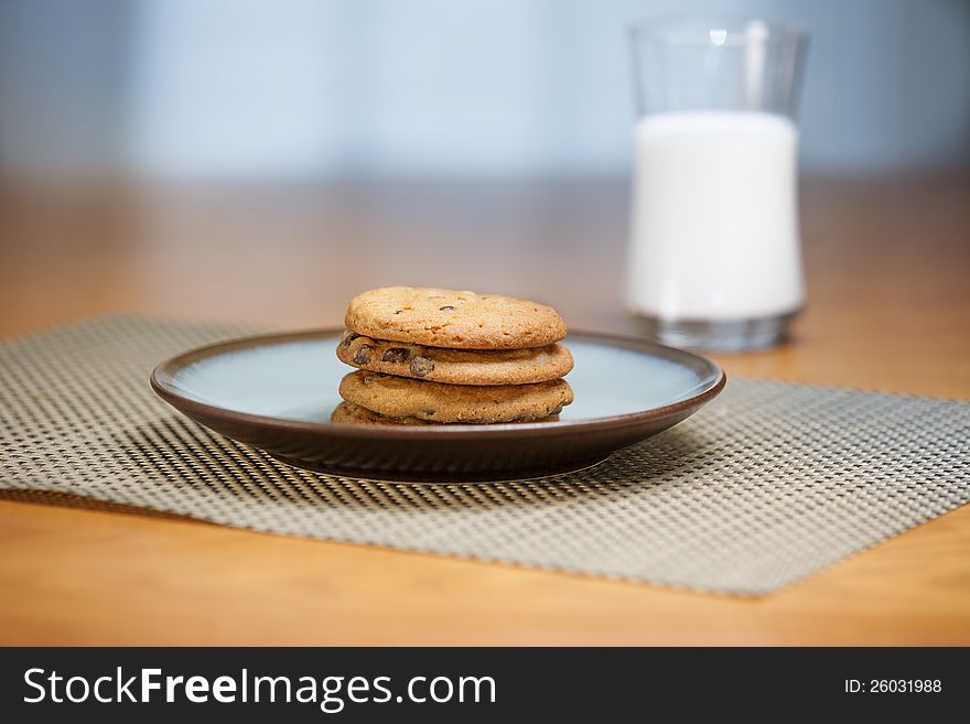 Cookies on plate with milk in background. Cookies on plate with milk in background