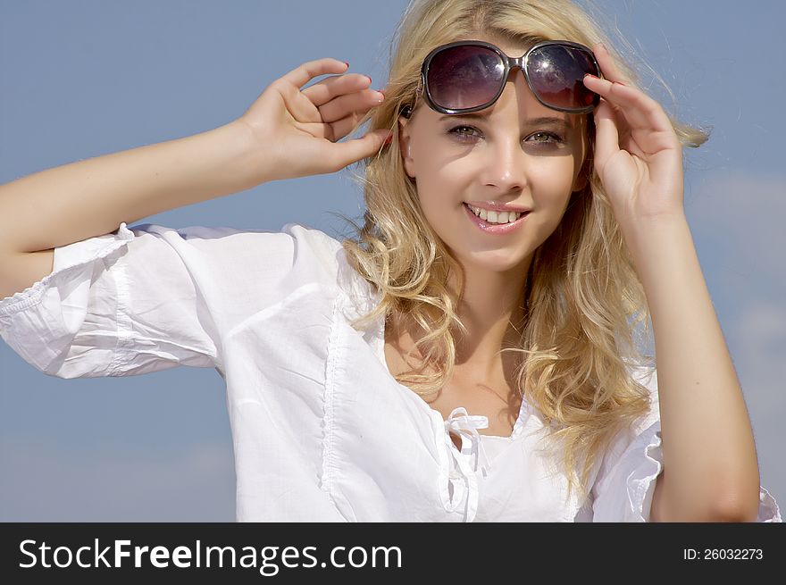 Beautiful Girl In Sunglasses On  Blue Sky