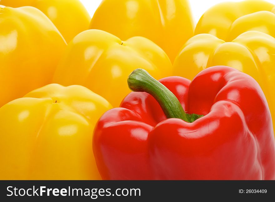 Background of One Red and Some Yellow Bell Peppers close up. Background of One Red and Some Yellow Bell Peppers close up