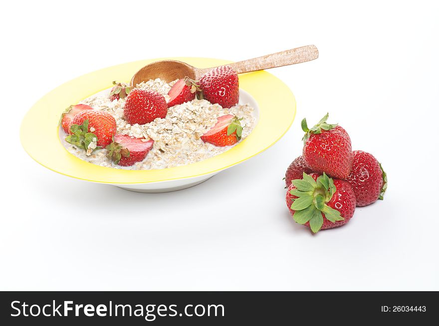 Healthy Muesli, Milk and Fresh Strawberry on Yellow plate with Wooden Spoon isolated on white background. Healthy Muesli, Milk and Fresh Strawberry on Yellow plate with Wooden Spoon isolated on white background