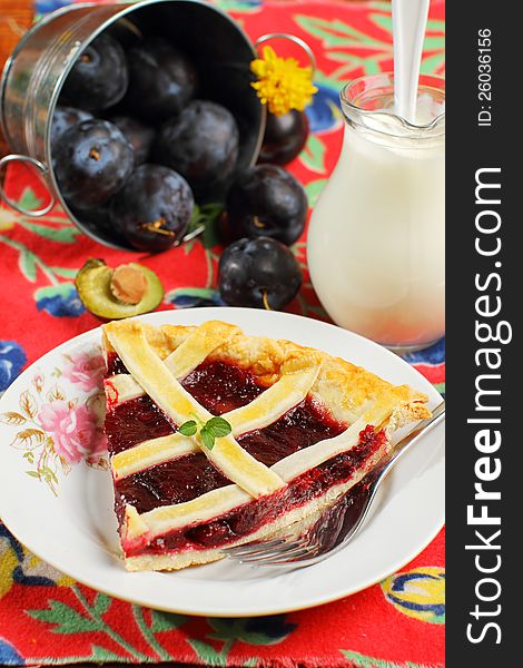 Slice of freshly baked plum cake in rustic decor