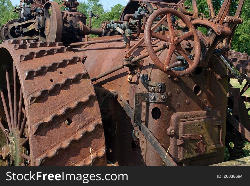 Rusty old iron tractor decaying in a field. Rusty old iron tractor decaying in a field