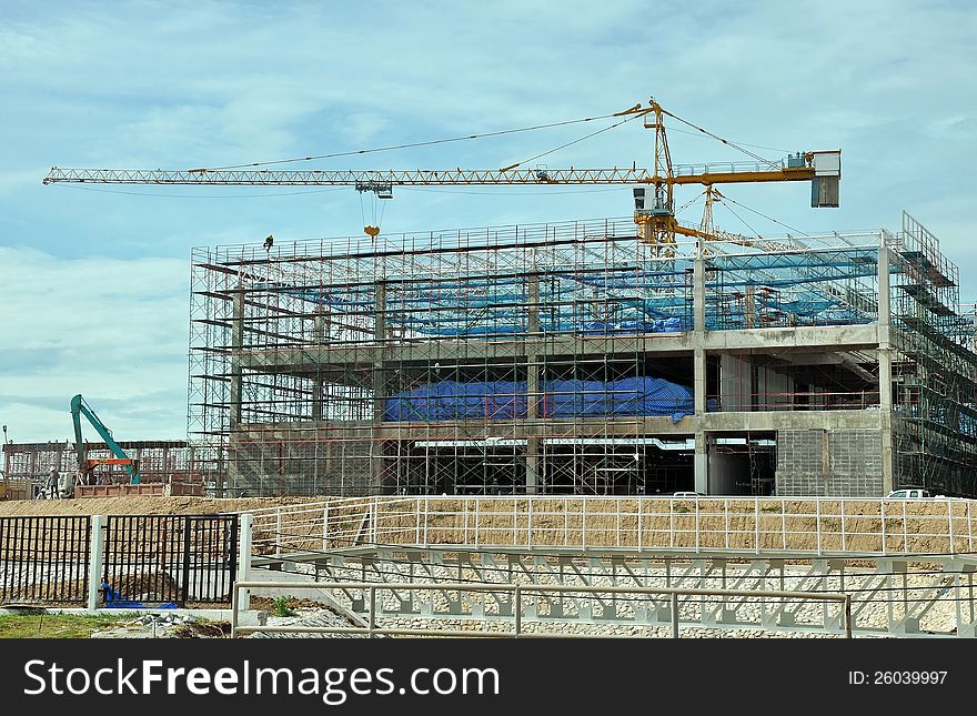 Building under construction with hanging worker on top