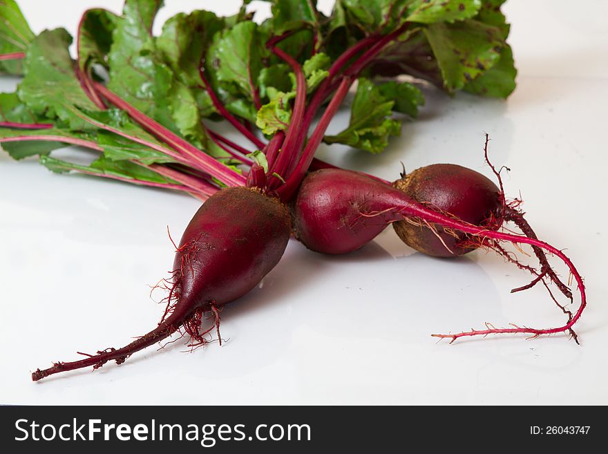 Beet closeup on white background with leaves. Beet closeup on white background with leaves