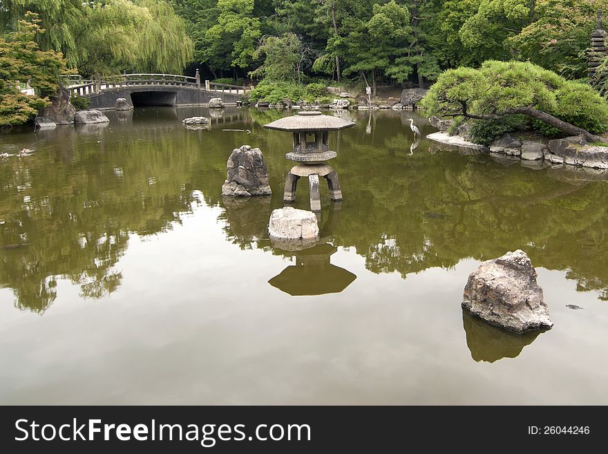 Scenic Japanese zen garden with big pond on foreground. Scenic Japanese zen garden with big pond on foreground