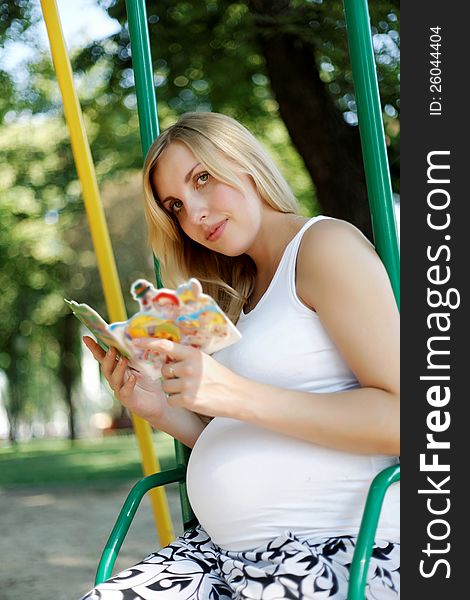 Pregnant Girl In A Park With A Book