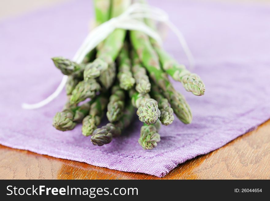 Green asparagus on purple napkin. Shallow dof