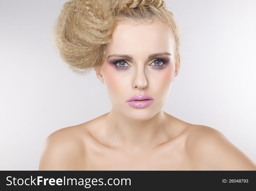 Young pretty woman with beautiful blond hairs and multicolor makeup isolated on white background