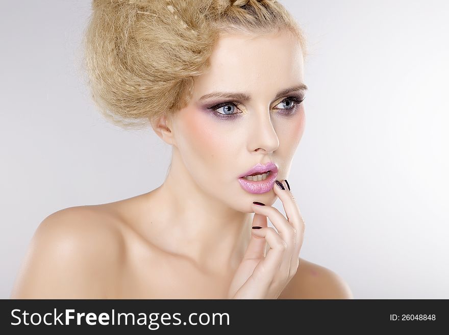Young pretty woman with beautiful blond hairs and multicolor makeup isolated on white background