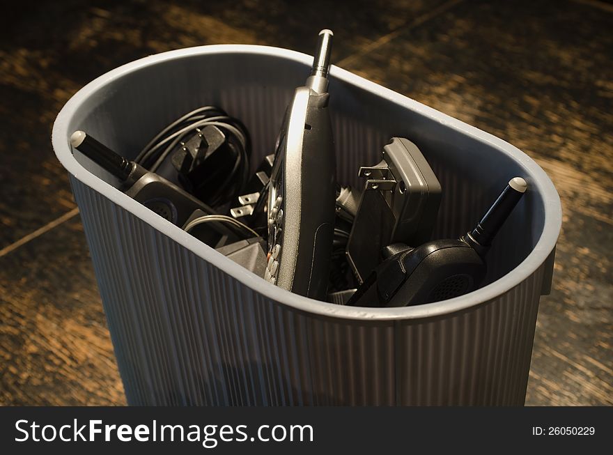 Home wired phones in trash basket. Home wired phones in trash basket