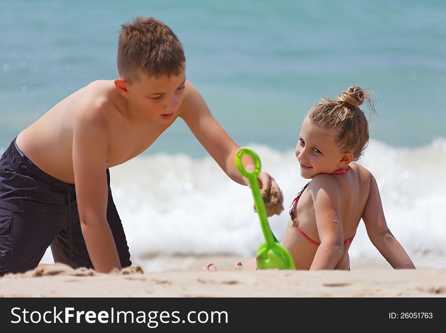 Children Playing On The Beach During