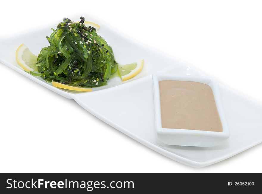 Salad and sauce on a white background algae