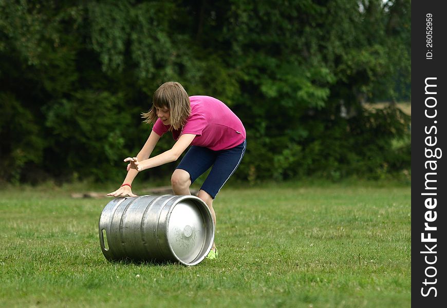 Young girl competes in rolling barrel. Young girl competes in rolling barrel.