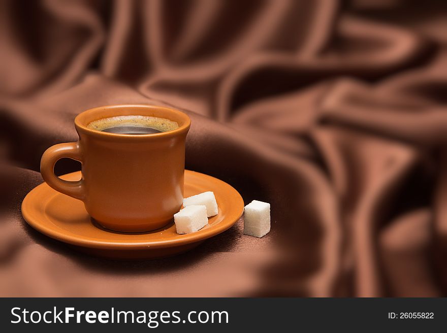 Cup with coffee on a background from  silk