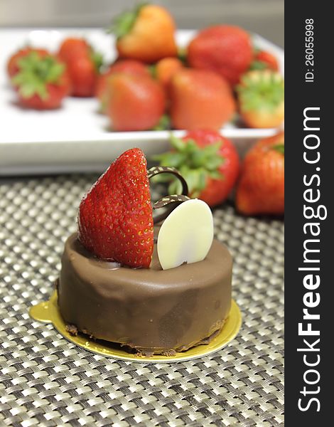 Dark chocolate cake decorated with fresh strawberries