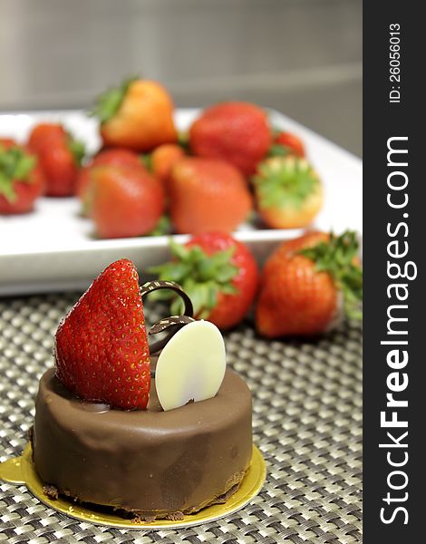 Dark chocolate cake decorated with fresh strawberries