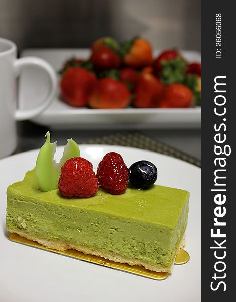 Green tea cheese cake ontop raspberry,bluberry