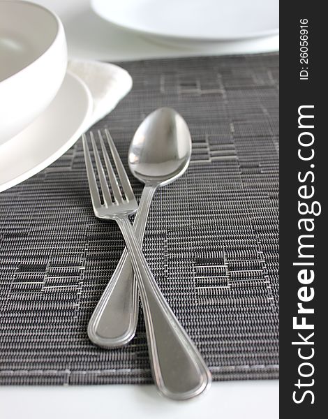 Spoon and Fork with a white bolw