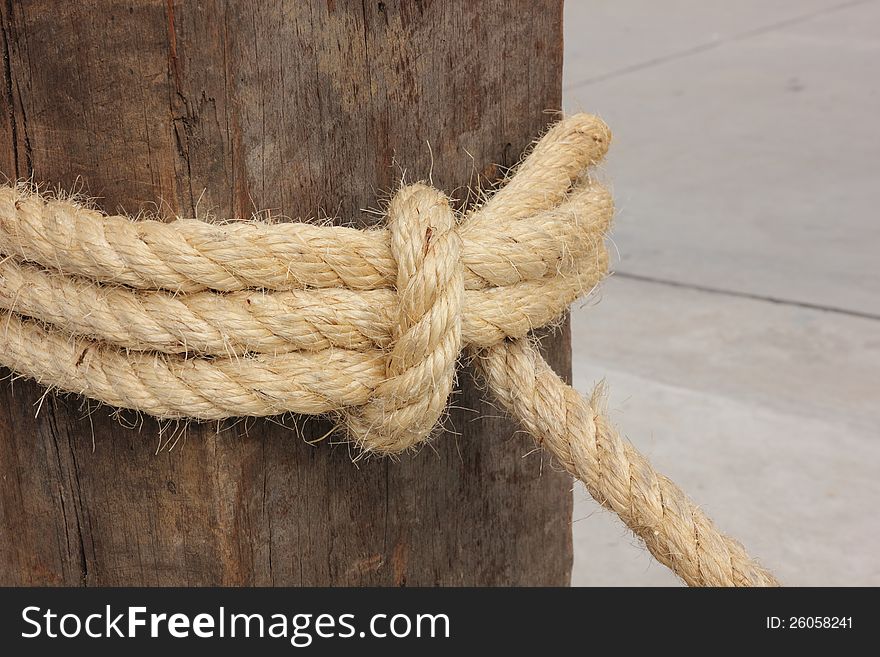 Close-up shot, Rope tied on wooden pole.