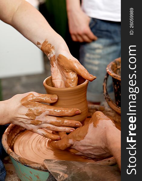 Potters make a pot of hands