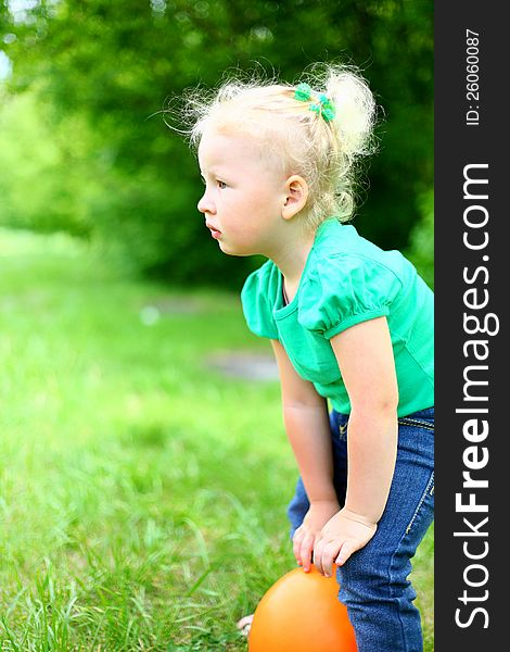 Portrait of a girl with a ball in the park