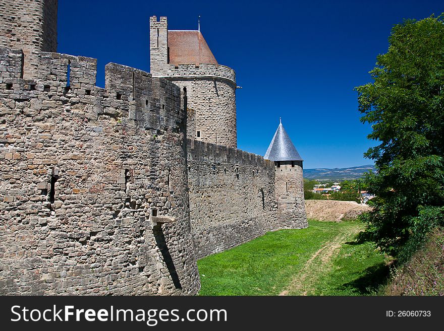 Carcassone castle back wall under blue sky. Carcassone castle back wall under blue sky