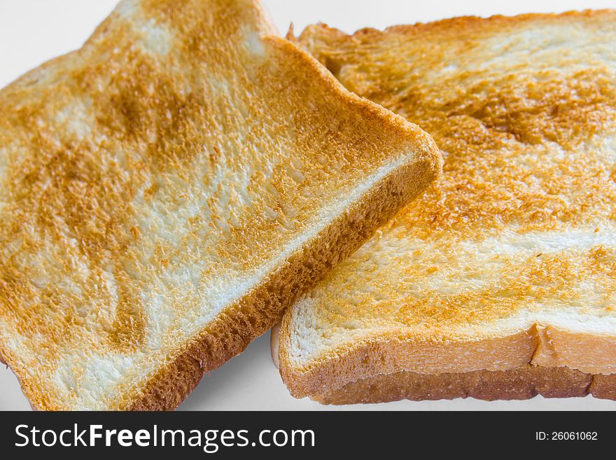 Crusty bread or sliced toast, on white background with natural shadow. Crusty bread or sliced toast, on white background with natural shadow