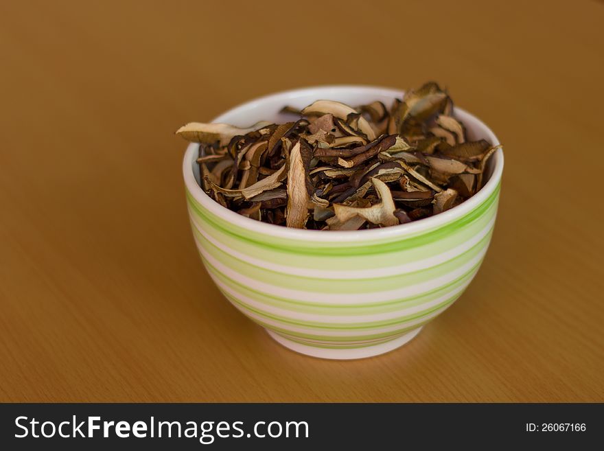 Sliced and dried mushrooms in a ceramic bowl. Sliced and dried mushrooms in a ceramic bowl.