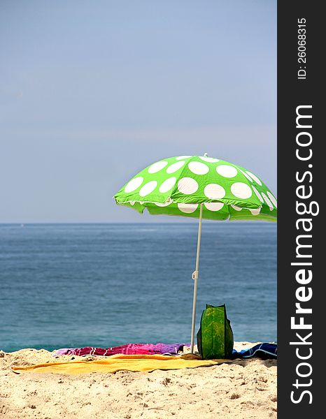 Sea time - funny green sun ubrella on the beach