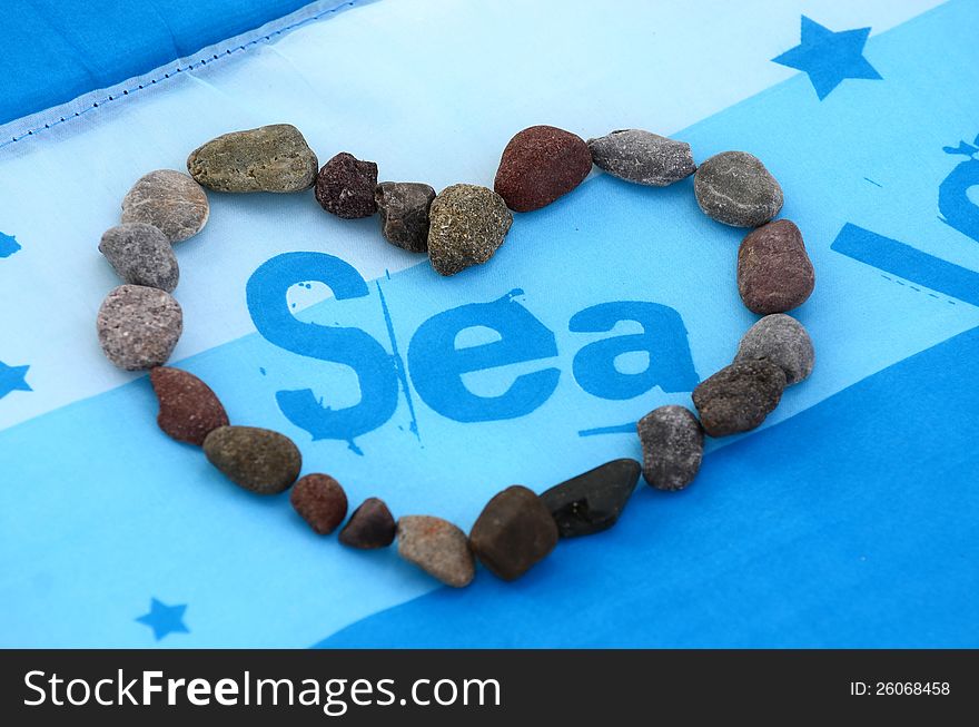 Heart of stones, love sea on blue background