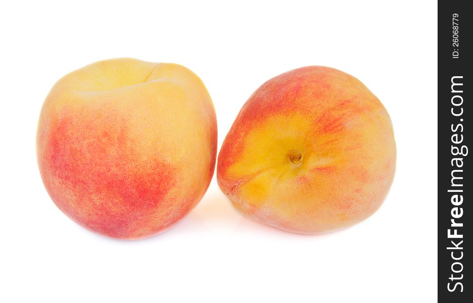 Tasty juicy peaches on a white background