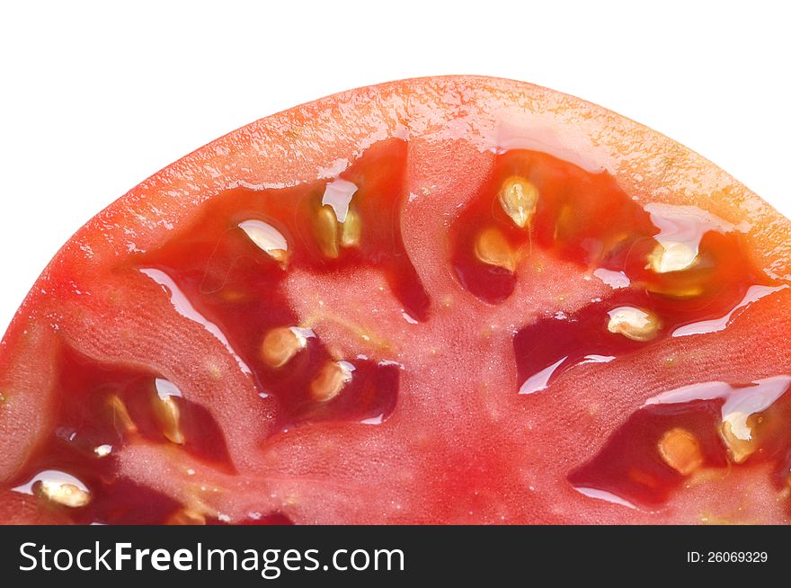 Macro closeup of half sliced tomato on white background. Macro closeup of half sliced tomato on white background