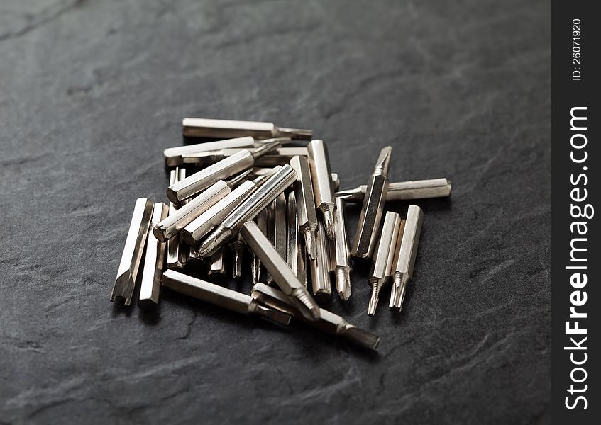 Closeup of stainless steel bits of screwdriver over black background. Closeup of stainless steel bits of screwdriver over black background