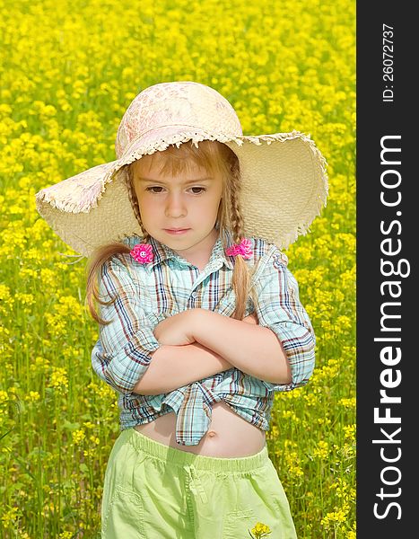 The sad little girl among a blossoming field. The sad little girl among a blossoming field