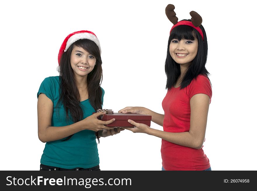 Two asian girls celebrate christmas isolated over white background. Two asian girls celebrate christmas isolated over white background