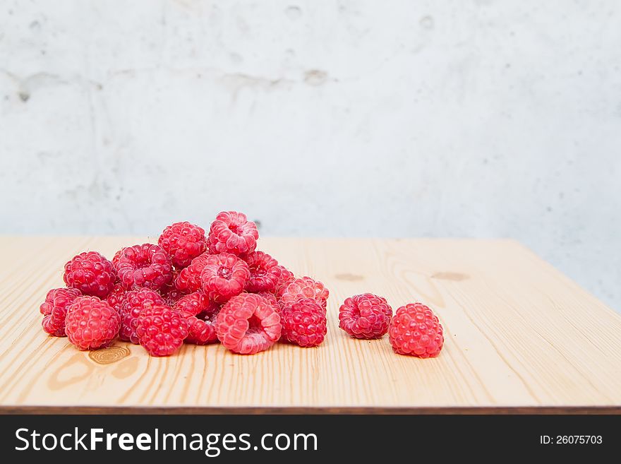 Fresh raspberries on wooden table
