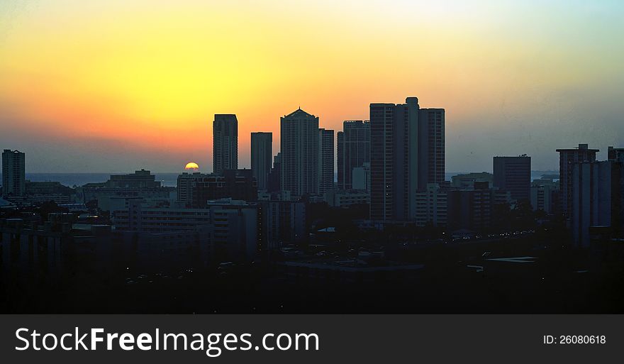 Last ray of sun goes behind a city skyline. Last ray of sun goes behind a city skyline