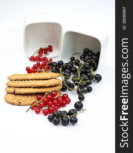 Red and black currant and cereal biscuits on a white background